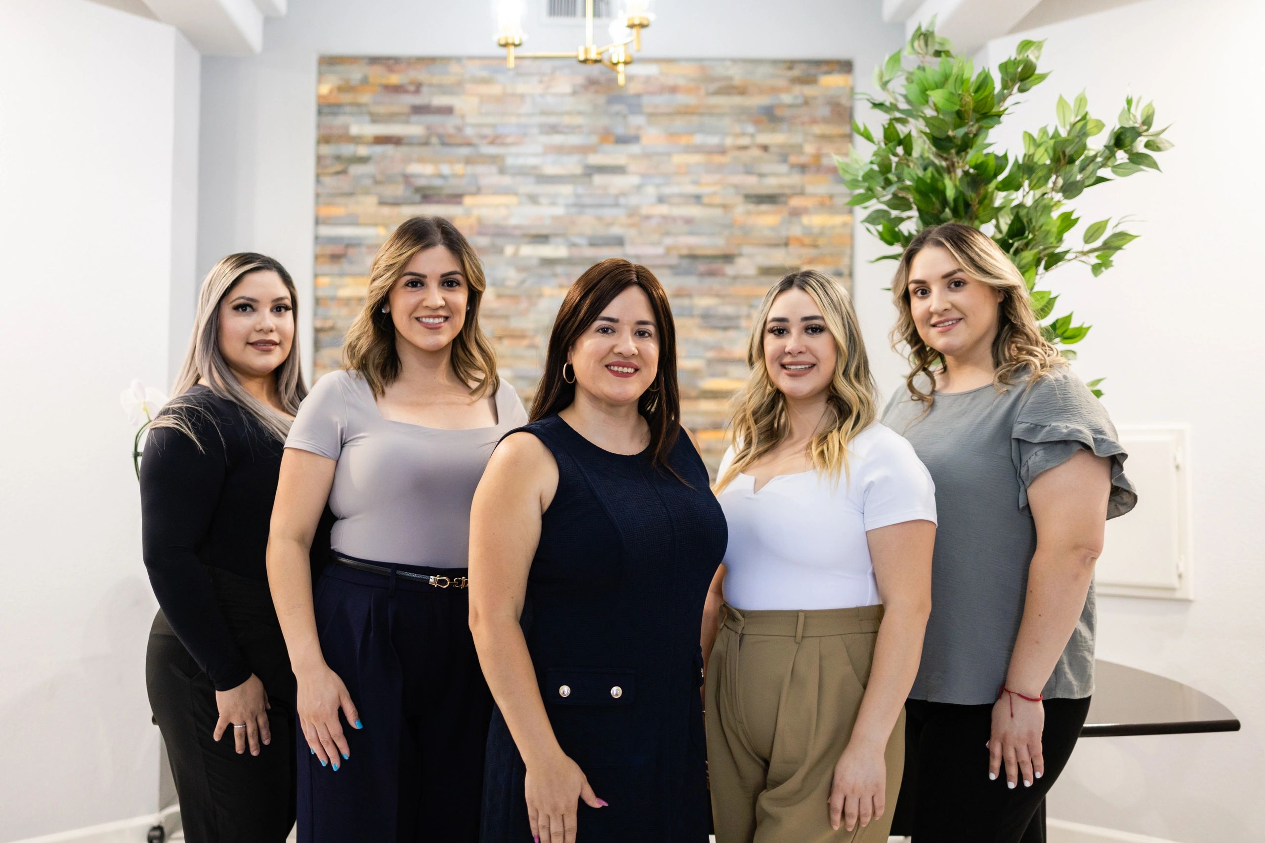 Five smiling women business team portrait.